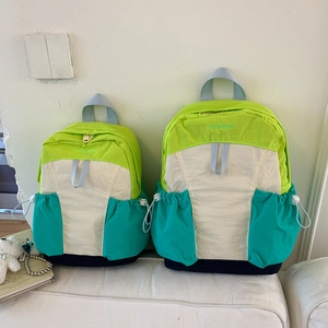 Close-up of color-block nylon school bag showing two sizes with side drawstring pockets