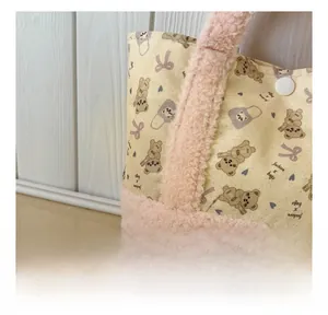Close-up of bear print canvas and pink plush fabric detailing on kids crossbody bag