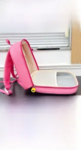Pink cartoon dinosaur toddler backpack showing side opening with mesh inner pockets and compartments