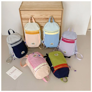 Detail view of multi-color minimalist kids backpacks with nylon fabric and zip pockets