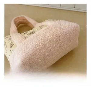 Detail view of plush pink faux fur and teddy bear printed fabric on a kids' handbag