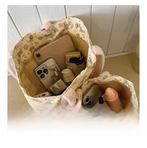 Detail showing internal capacity of bear print canvas bags with pink plush handles