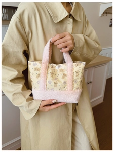 Macro detail of plush teddy bear crossbody bag featuring soft sherpa trim and snap closure