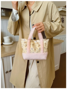 Detail of cute bear print shoulder bag with pink plush trim and button closure
