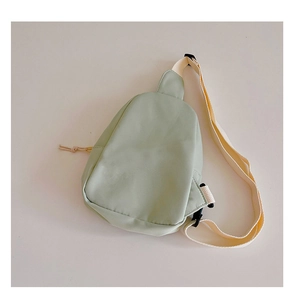 Detail of light green nylon kids chest bag with adjustable strap and buckle closure