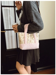 Detail of cute bear printed tote bag with pink plush handles and snap button closure