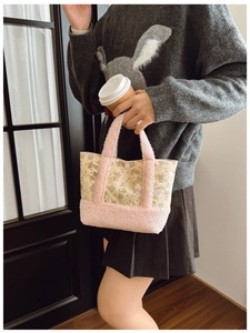 Detail of cute bear print toddler bag with pink fleece strap in a lifestyle setting