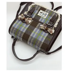 Detailed macro shot of vintage plaid school backpack with lace trim and bows