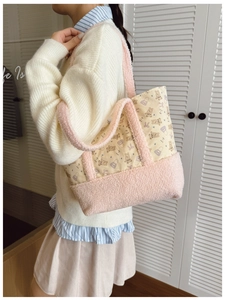 Detail of pink fleece handles and cute bear print on a stylish children plush handbag