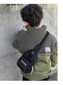 Detailed view of kids black nylon crossbody bag with Dream letter print and buckle strap