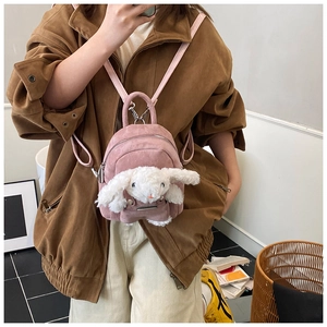 Close-up of pink corduroy toddler backpack featuring 3D plush bunny and silver zipper