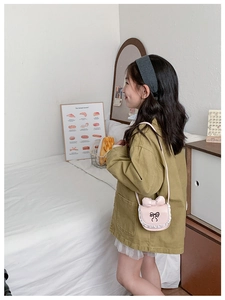 Pink girl shoulder bag with 3D bow, lace trim and long strap shown on model in bedroom