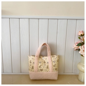 Close-up of bear print kids shoulder bag featuring pink fleece handle and button detail
