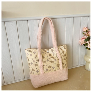 Detailed close-up of cute bear print canvas tote with pink plush handle and button closure