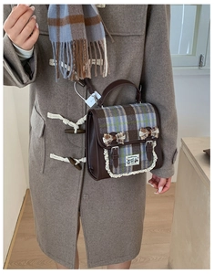Detail of British style plaid crossbody bag with lace edges and bow decorations