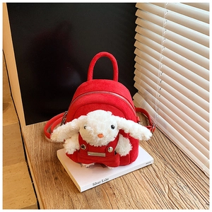 Detailed macro of a soft red velvet kids backpack with a cute plush white bunny doll