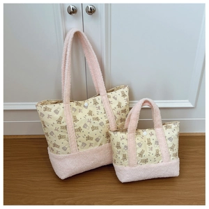 Close-up of cute bear print fabric and pink fleece texture on toddler crossbody bags