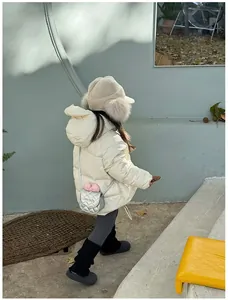Détail du sac bandoulière argenté matelassé avec texte Love Baby sur veste blanche enfant