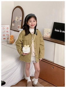 Detail of girls' olive utility jacket with contrast collar and white bow crossbody bag