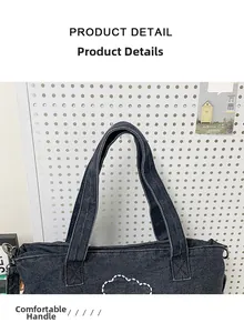 Close-up of comfortable denim handles and cloud stitching on this large tote bag