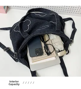 Detailed view of the denim cloud tote bag internal capacity for books and umbrella