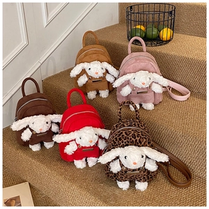 Detail view of five assorted plush bunny backpacks in suede texture and various colors