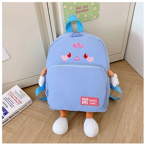 Detail of light blue cartoon schoolbag with plush limb decorations and cute embroidery