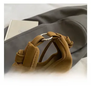 Detail of comfortable knotted handle on brown leather kids bear bag with soft texture