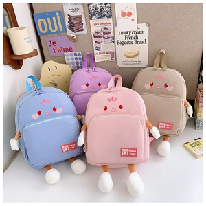 Detailed display of colorful cartoon backpacks for children in pink, blue, and beige