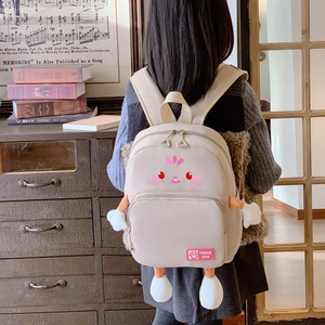 Beige cartoon kid backpack with cute smiley embroidery and 3D plush limbs for school
