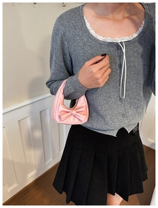 Detail of pink bow handbag for girls showing smooth PU leather and silver zipper