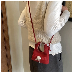 Detail of red mini crossbody bag with cute teddy bear embroidery and plaid bow