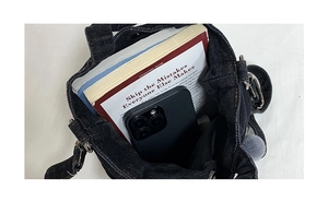 Top view of denim tote bag interior showing capacity for books and a smartphone