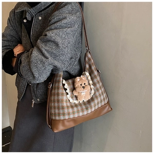 Detail of checkered shoulder bag with lace trim and 3D plush bear charm for children
