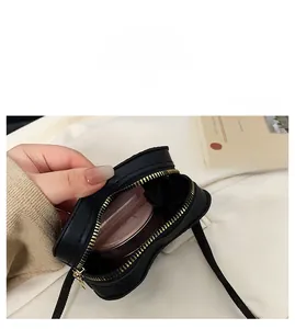Capacity detail of black heart-shaped crossbody bag showing internal storage space