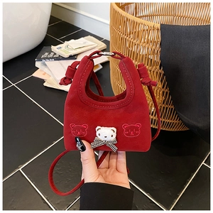 Detail of red mini handbag for girls featuring 3D plush bear and bow decoration