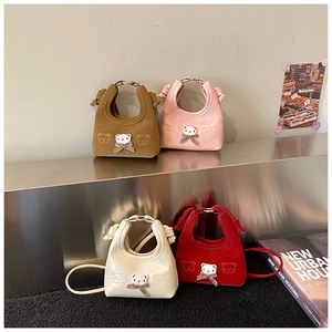Detailed view of mini cartoon bear hobo bags in brown, pink, off-white, and red colors