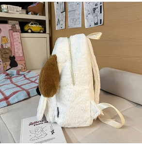 Detail view of the plush puppy backpack featuring a metal zipper and soft long brown ears