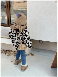 Detail of leopard print faux fur jacket for kids with beige knit scarf and shoulder bag