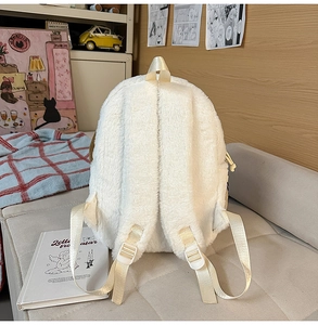 Adjustable nylon straps and soft plush texture on back of the white puppy backpack