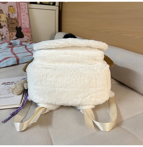 Close-up of fluffy white plush backpack with black nose and floppy brown ears detail