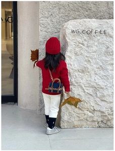 Detailed back view of mini blue denim and brown leather crossbody bag for kids