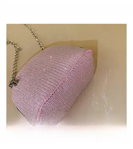 Detail shot of a pink sequin shell-shaped bag with a silver chain strap and zipper