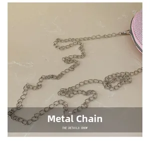 Close-up of pink sequin bag featuring high-quality silver hardware metal chain strap