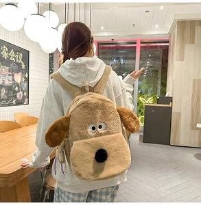 Detail shot of the plush Gromit dog backpack with long fur on a model's back