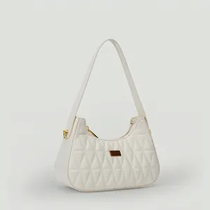 Minimalist white quilted underarm bag with triangular patterns and gold hardware detail