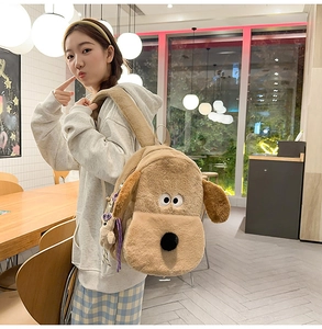 Detail of the soft brown plush dog backpack with long floppy ears and a cute hanging charm