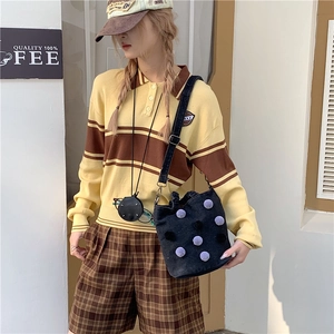 Polka dot denim bucket bag with plush purple poms for casual autumn fashion style
