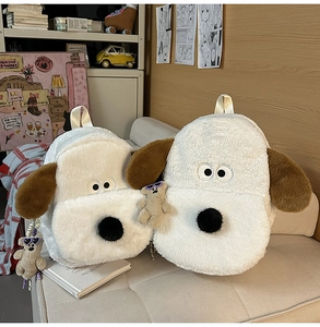Close-up of cute Gromit-style plush dog backpack with small mini bag and bear charm