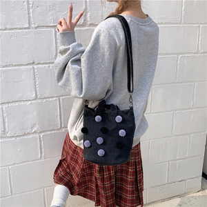Denim bucket bag with colorful plush polka dots and adjustable shoulder strap for women